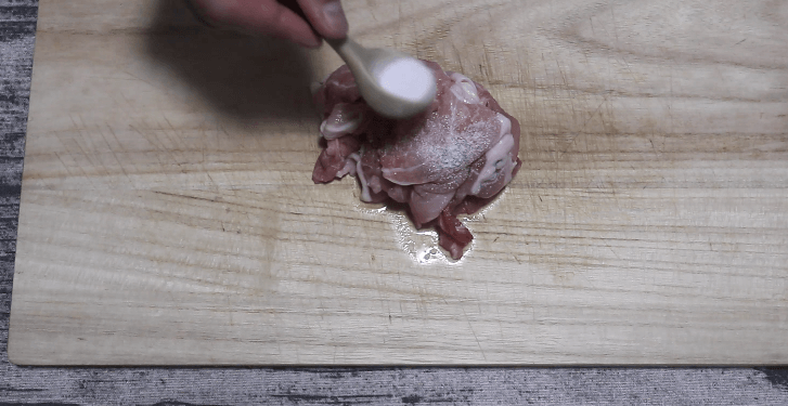 豚こま切れ肉に塩をかける
